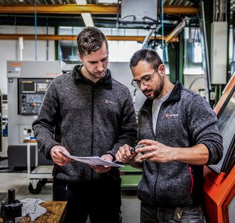Zwei Mitarbeiter unterhalten sich in der Produktion von Kern Antriebstechnik